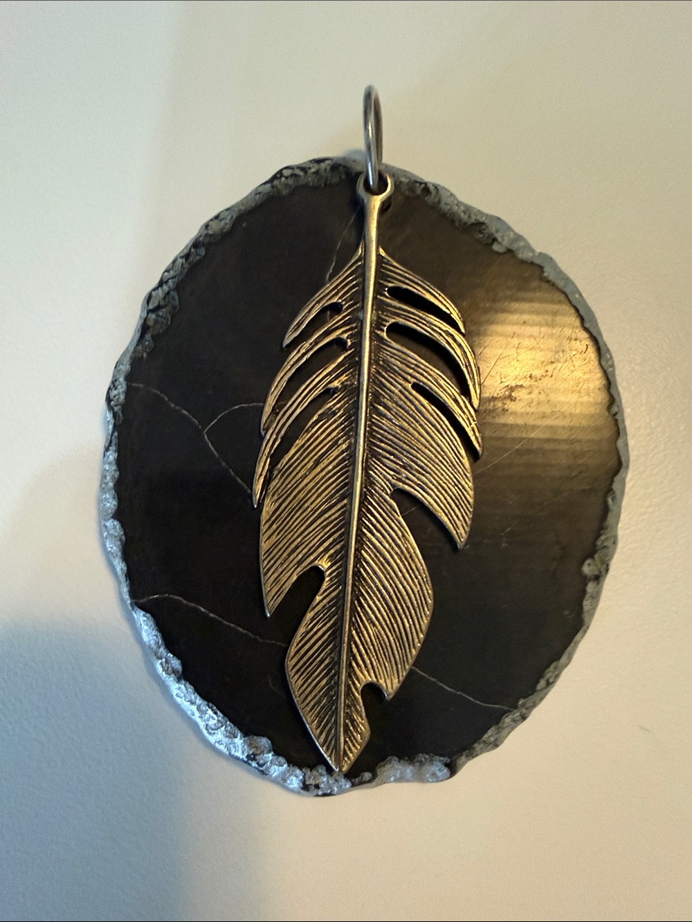 Bronze Feather Pendant on Black “stone” with altered silver edges